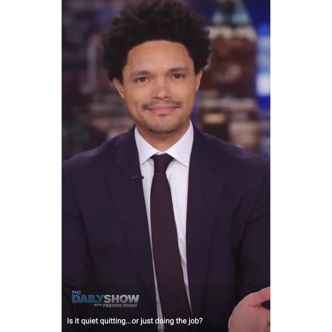 Still of Trevor Noah, the host of "The Daily Show." H's wearing a dark suit and tie and a white shirt.