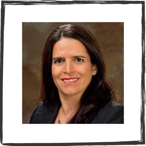 Photo of a Latina woman with shoulder-length, brown hair, brown eyes & wearing a dark suit jacket