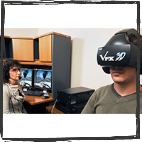A man sits on the right wearing a virtual reality headset while a woman watches him sitting at a desk on the left