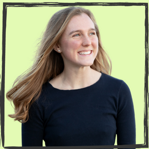 A young white woman w/long, light-brown hair looks right and smiles