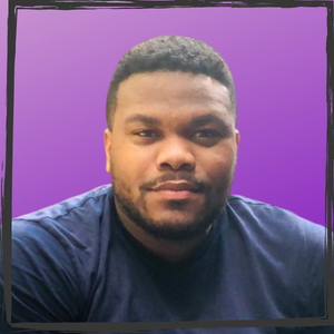 A Black man w/short hair & wearing a blue shirt on a purple gradient background