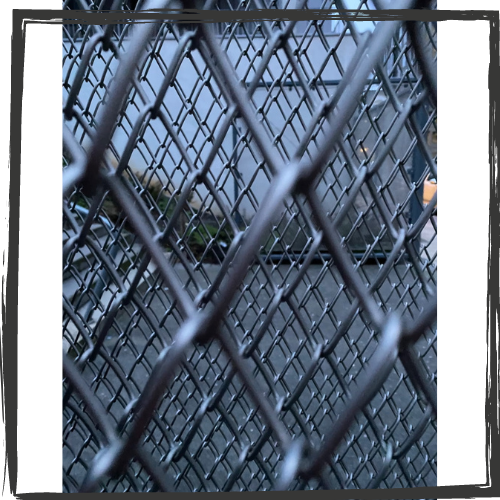 Photo of chain link looking through five different layers at various distances 